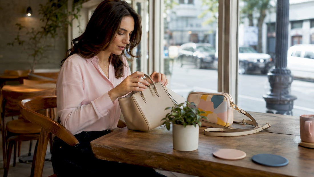 Woman organizing professional handbags at desk